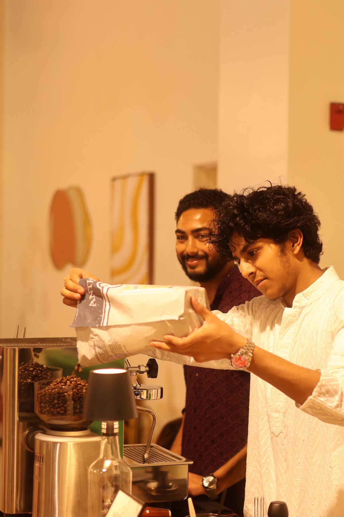 Barista loading beans into the grinder