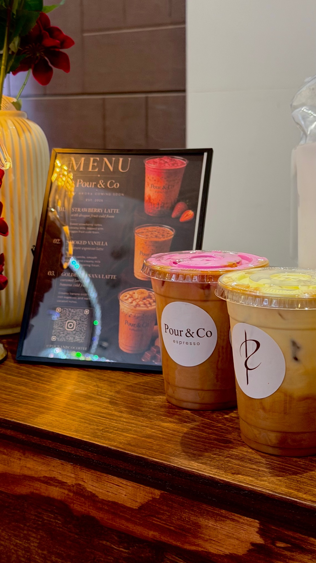 Espresso tonic and menu card on walnut